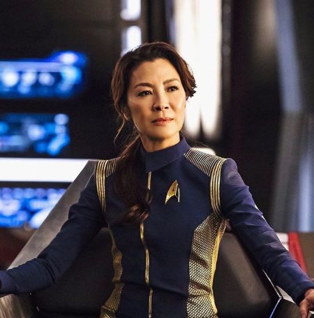 Michelle Yeoh is posing for her post.